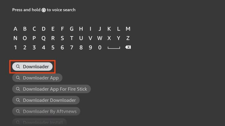 This image shows the search screen on an Amazon Fire TV Stick interface. The user is in the process of typing “Downloader” using the on-screen keyboard.