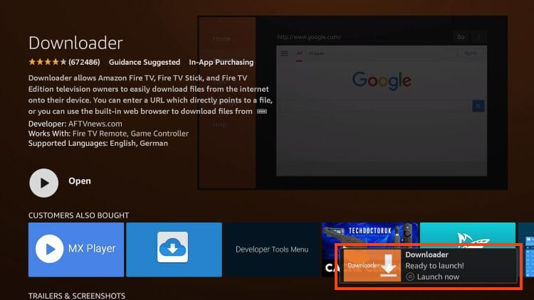 This image shows the Downloader app installation complete screen on an Amazon FireStick or Fire TV device. Key highlights: The Downloader app has been successfully installed, as indicated by the notification in the bottom-right corner: Text: 🔽 Downloader – Ready to launch! 🟢 Launch now The main "Open" button has replaced the download button on the left side, allowing the user to start the app immediately. The page still displays the app details: Developer: AFTVnews.com Works With: Fire TV Remote, Game Controller Supported Languages: English, German Bottom Row: Recommended apps like MX Player and Developer Tools Menu are shown under "Customers Also Bought". This screen appears right after downloading and installing the Downloader app, which is essential for sideloading IPTV players like Smart IPTV, TiviMate, or IPTV Smarters Pro.